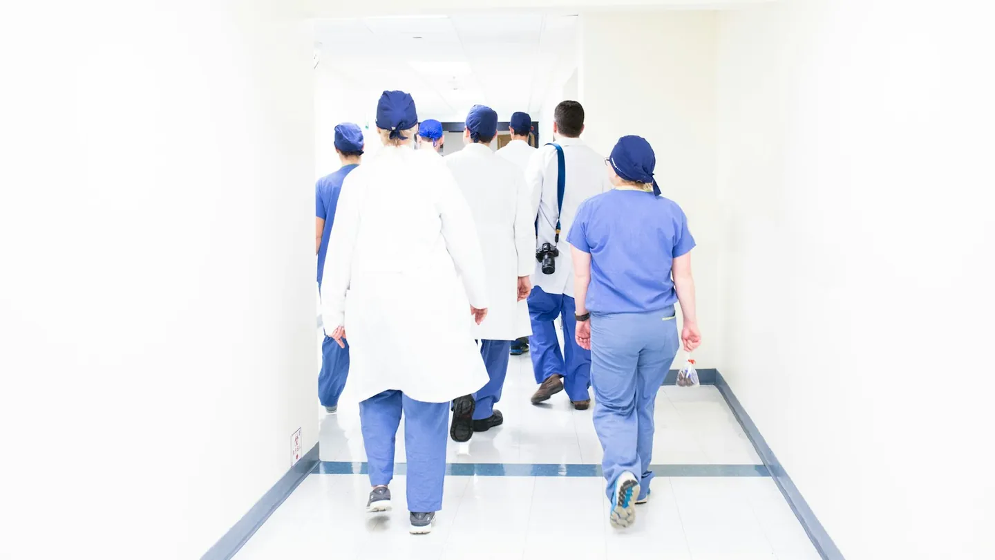 Doctors walking through a hospital hallway during residency training.
