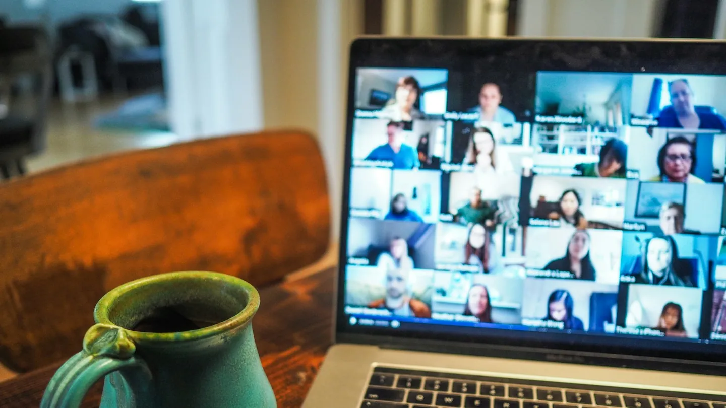 Laptop open on a desk during a video interview call.